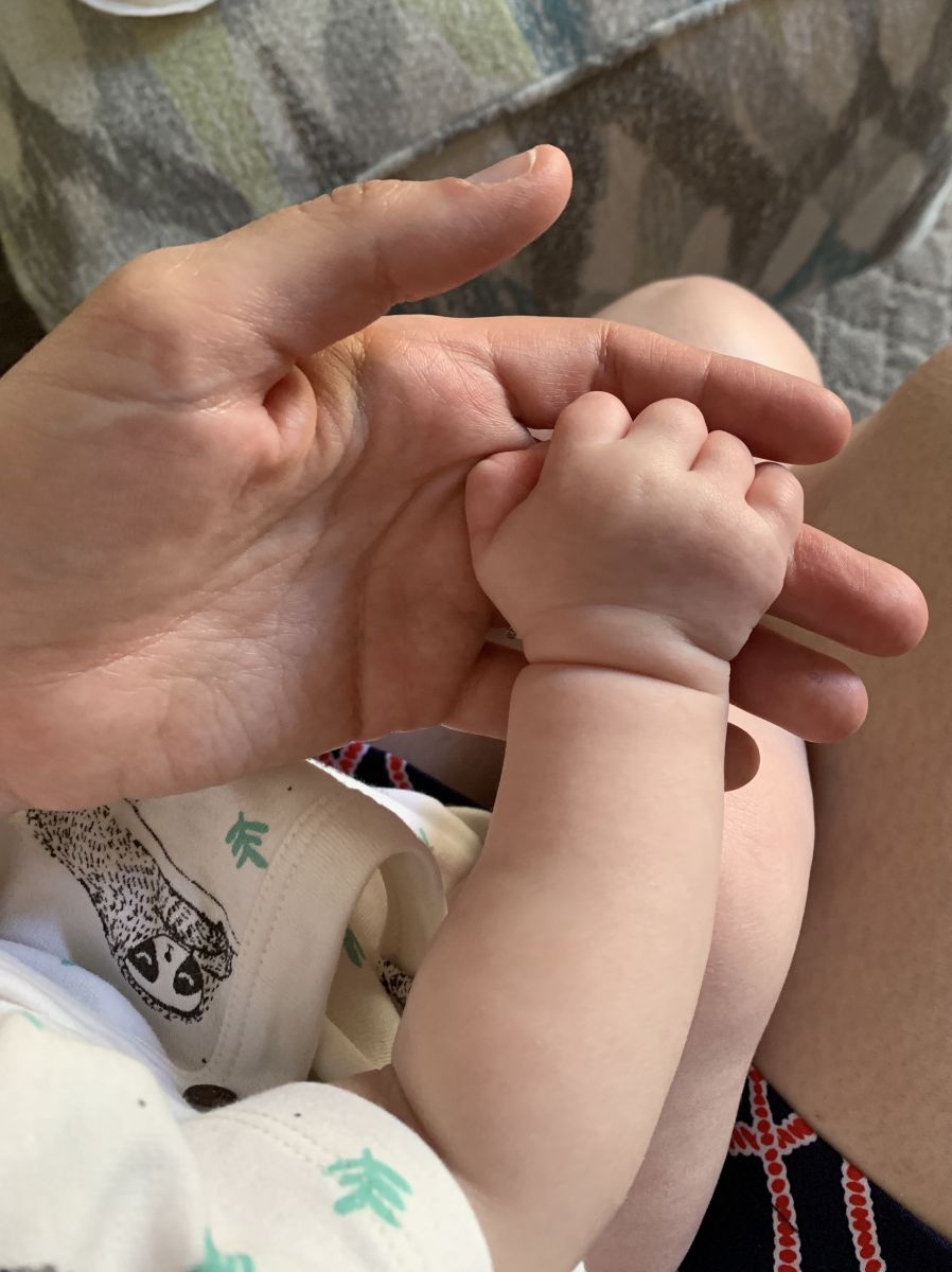 tiny baby hand in mama's hand
