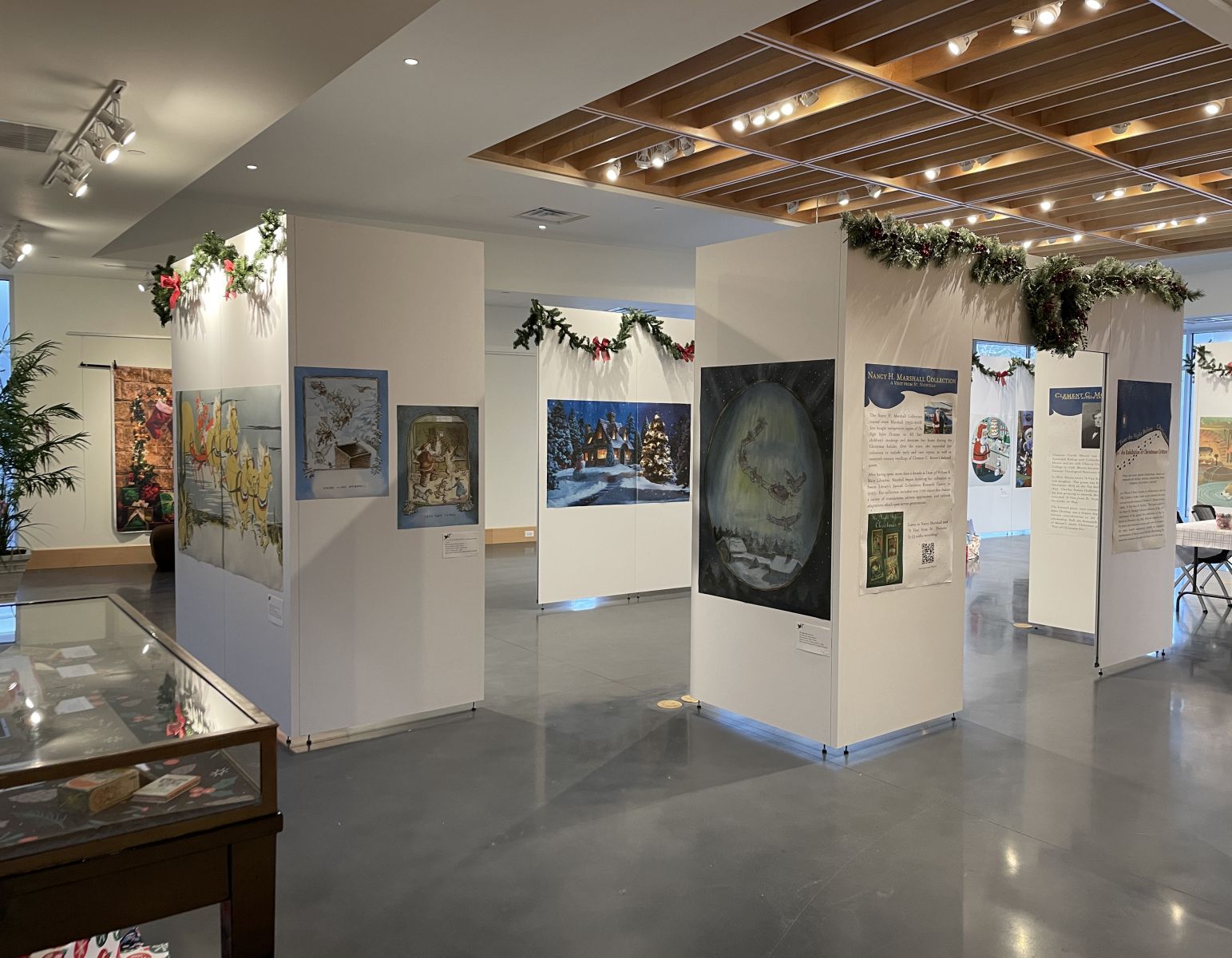 Gallery shot of 'Twas the Night Before Christmas: An Exhibition of Christmas Critters with large scale images on moveable exhibit walls
