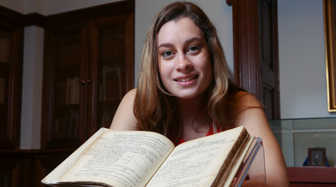 Caitlin Dolt posing with open book 