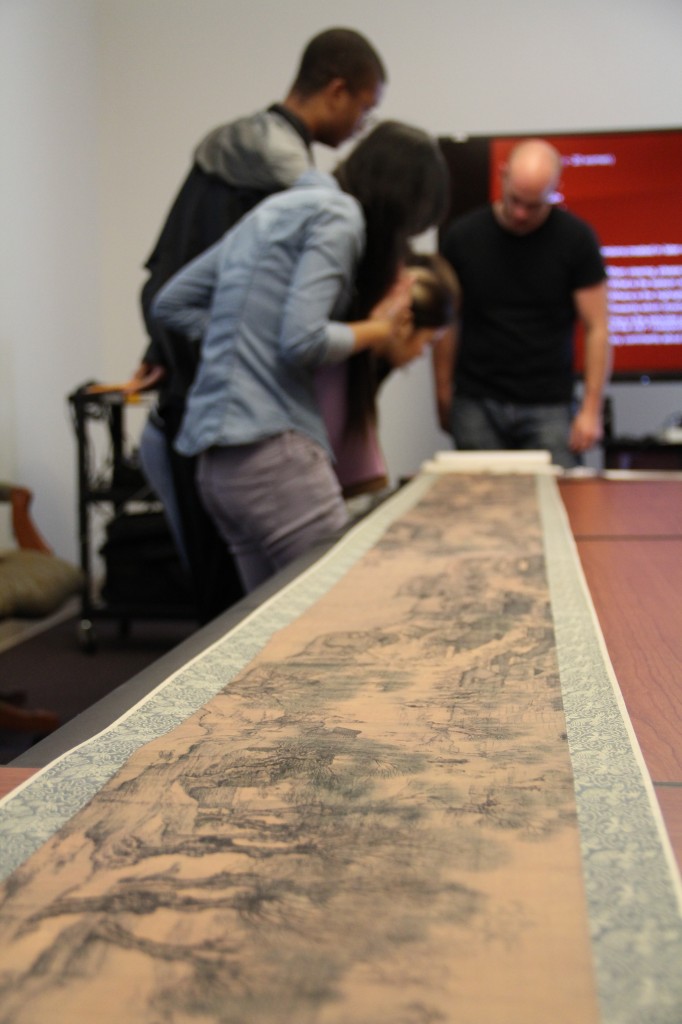 Wu's students examine "Scenes along the river during the Qingming Festival" facsimile handscroll