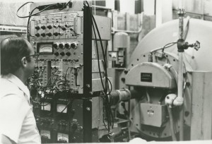 Dr. David C. Burkle monitors the controls of the 4 million volt Van de Graaff accelerator.