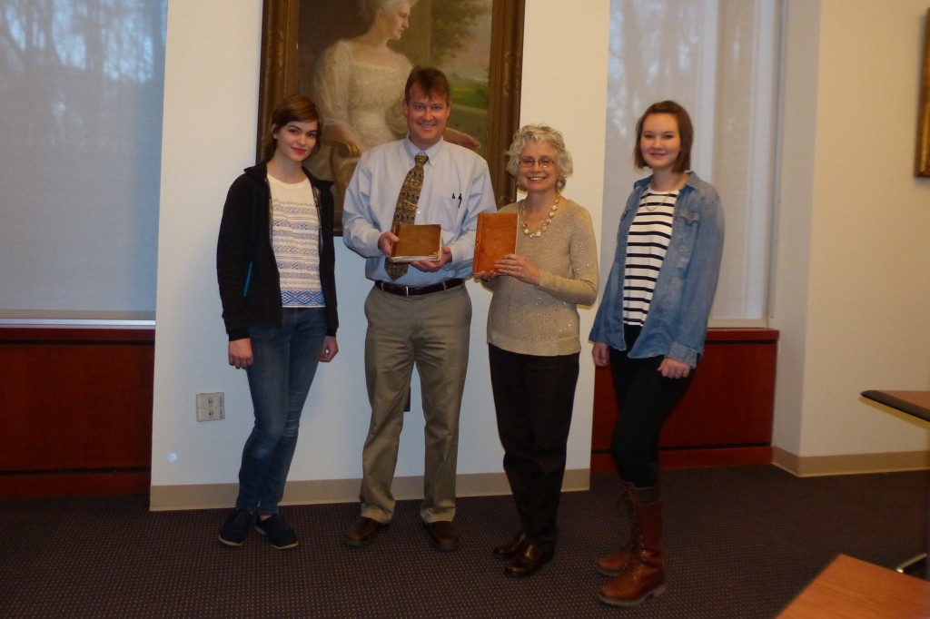 Mrs. Laura K. Lawrence donates Captain Walter P. Snow's Commonplace Book to Special Collections. With student transcribers, Greta Berckmueller and Emma Curtis.