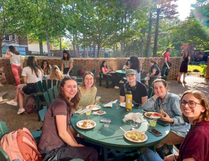 Students seated outdoors on the Conservation Patio enjoying the Libraries' end of the year student party