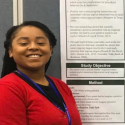 Photo of Jada Copeland in front of research presentation