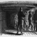 a black and white sketch of a ships prison hull with a line of white prisoners going into a cell 